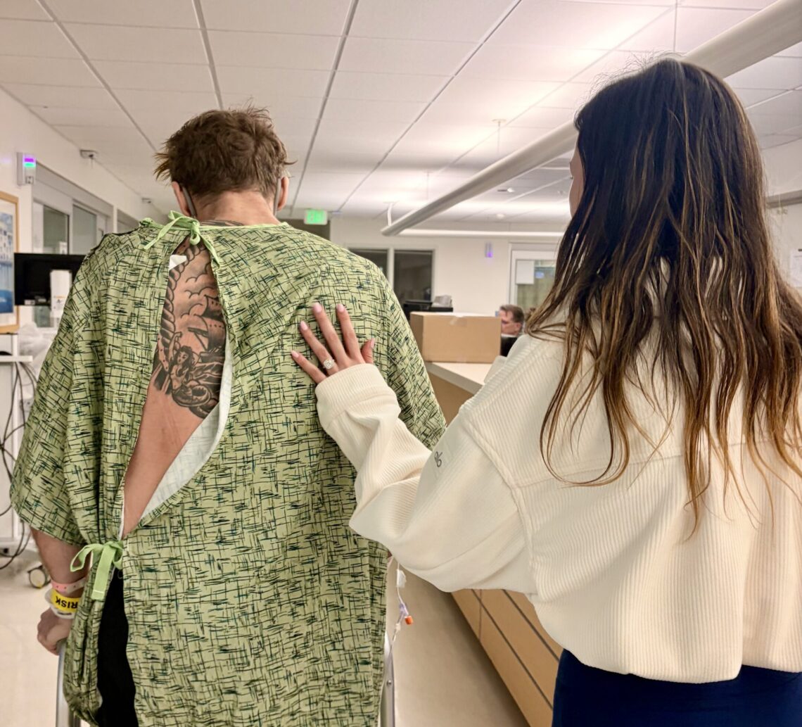 Juliette Fechter guiding fiance David Brackett through hospital.